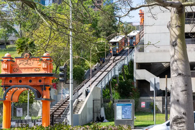Angels Flight orange arch on Hill Street with the funicular cars climbing Bunker Hill