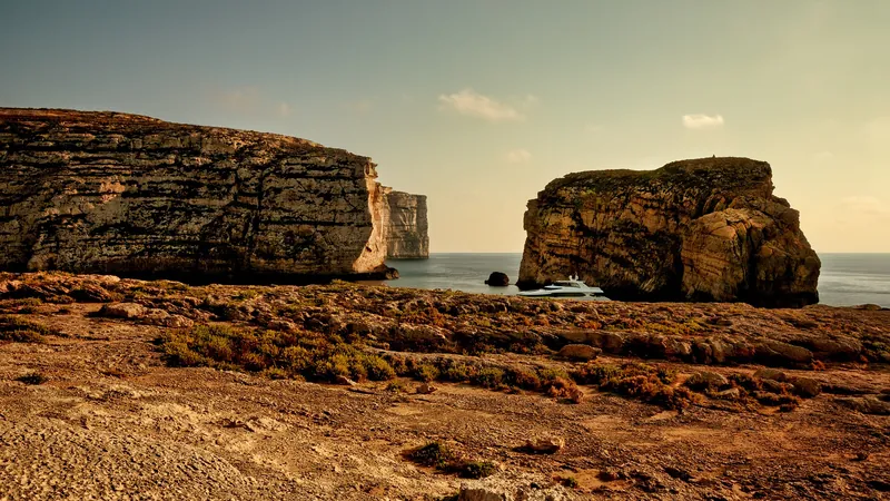 Fungus Rock and the limestone shore of Dwejra Bay on Gozo