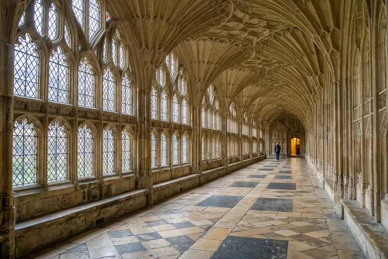 The fan-vaulted cloister of Gloucester Cathedral with its tall leaded windows, used for Hogwarts corridors