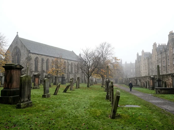 Old leaning gravestones in Greyfriars Kirkyard, Edinburgh, on a misty autumn day