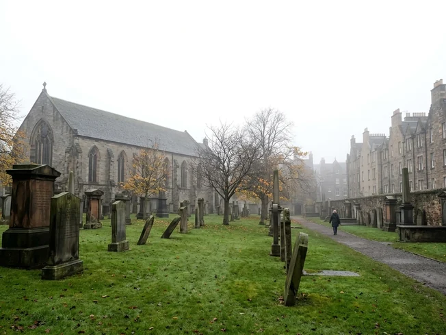 Old leaning gravestones in Greyfriars Kirkyard, Edinburgh, on a misty autumn day