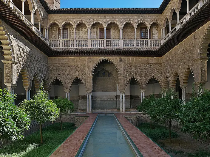 The long reflecting pool of the Patio de las Doncellas in the Real Alcázar of Seville