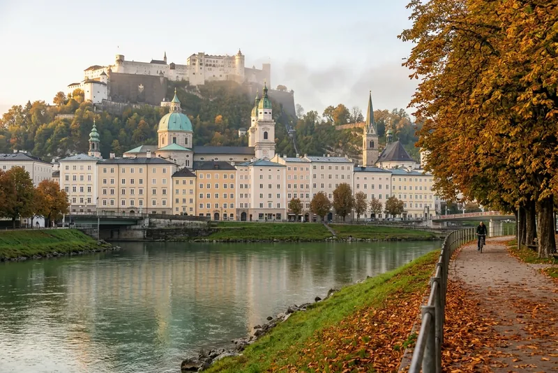 Salzburg old town across the Salzach in autumn, with the cathedral domes and Hohensalzburg fortress