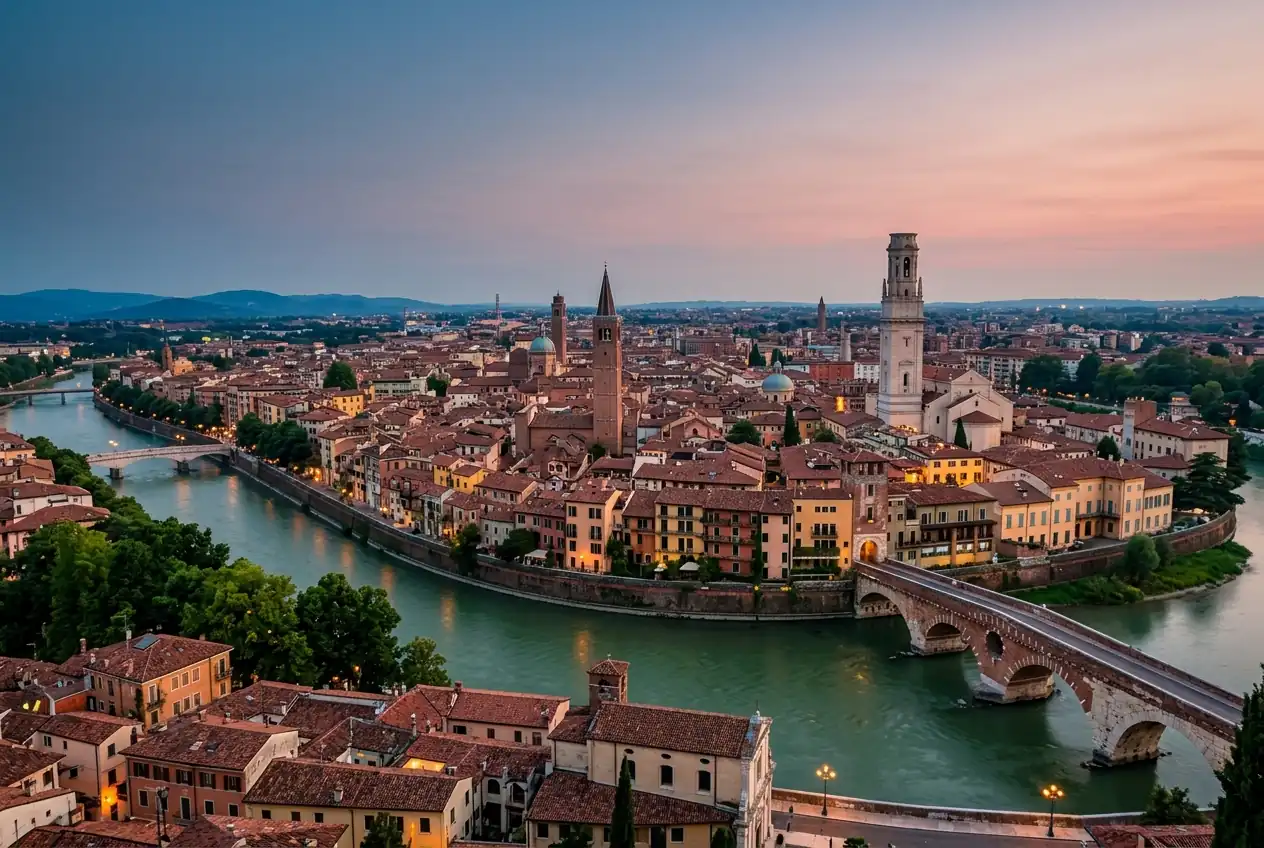 Verona at dusk from the hillside above the Adige, with the arches of Ponte Pietra lit